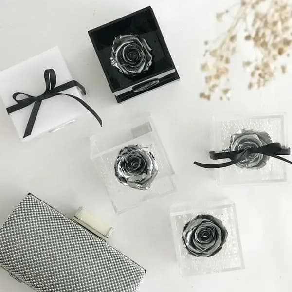 Silver roses in transparent boxes
