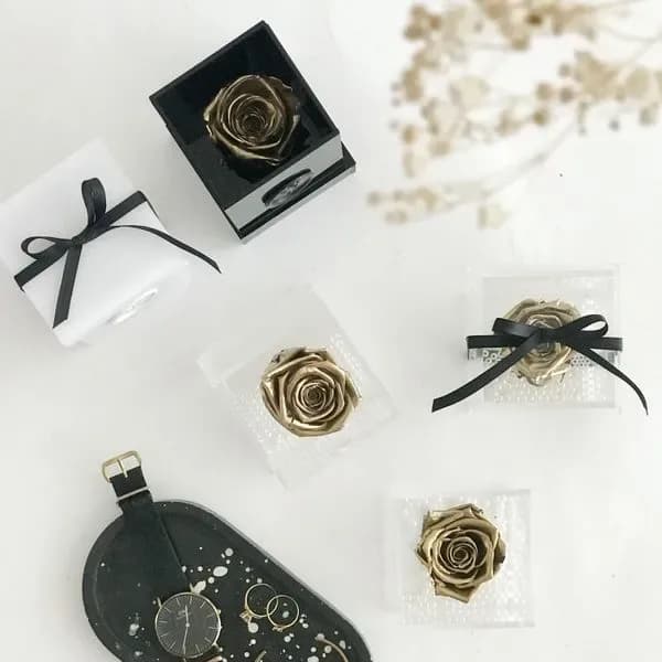 Gold roses in transparent boxes