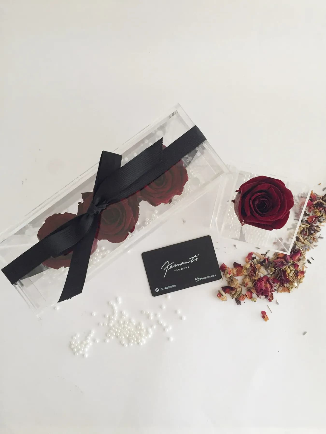 Red preserved rose in a clear acrylic box with a Ferranti card